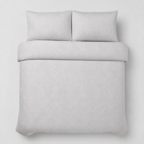 Overhead flat lay of the Embossed Geo Microfibre Duvet Cover Set in grey with two matching pillowcases