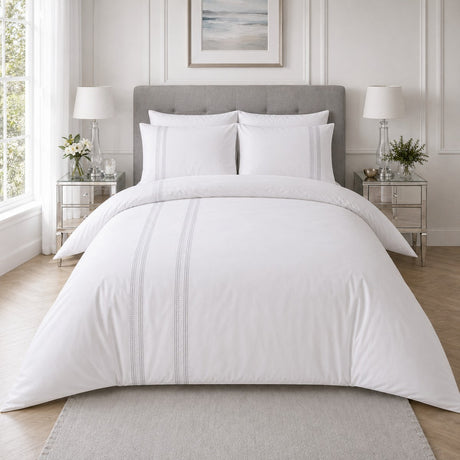 Embroidered Band silver cotton duvet cover set styled on a clean white bedroom bed