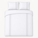 Overhead flat lay of the Embroidered Band silver cotton duvet cover set with two pillows