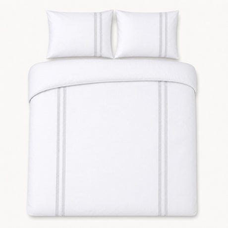 Overhead flat lay of the Embroidered Band silver cotton duvet cover set with two pillows
