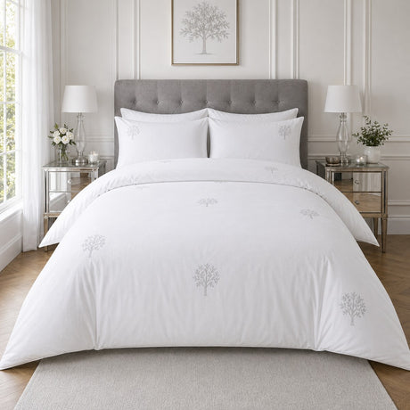 Embroidered Trees white cotton duvet cover set styled on a clean bright bedroom bed