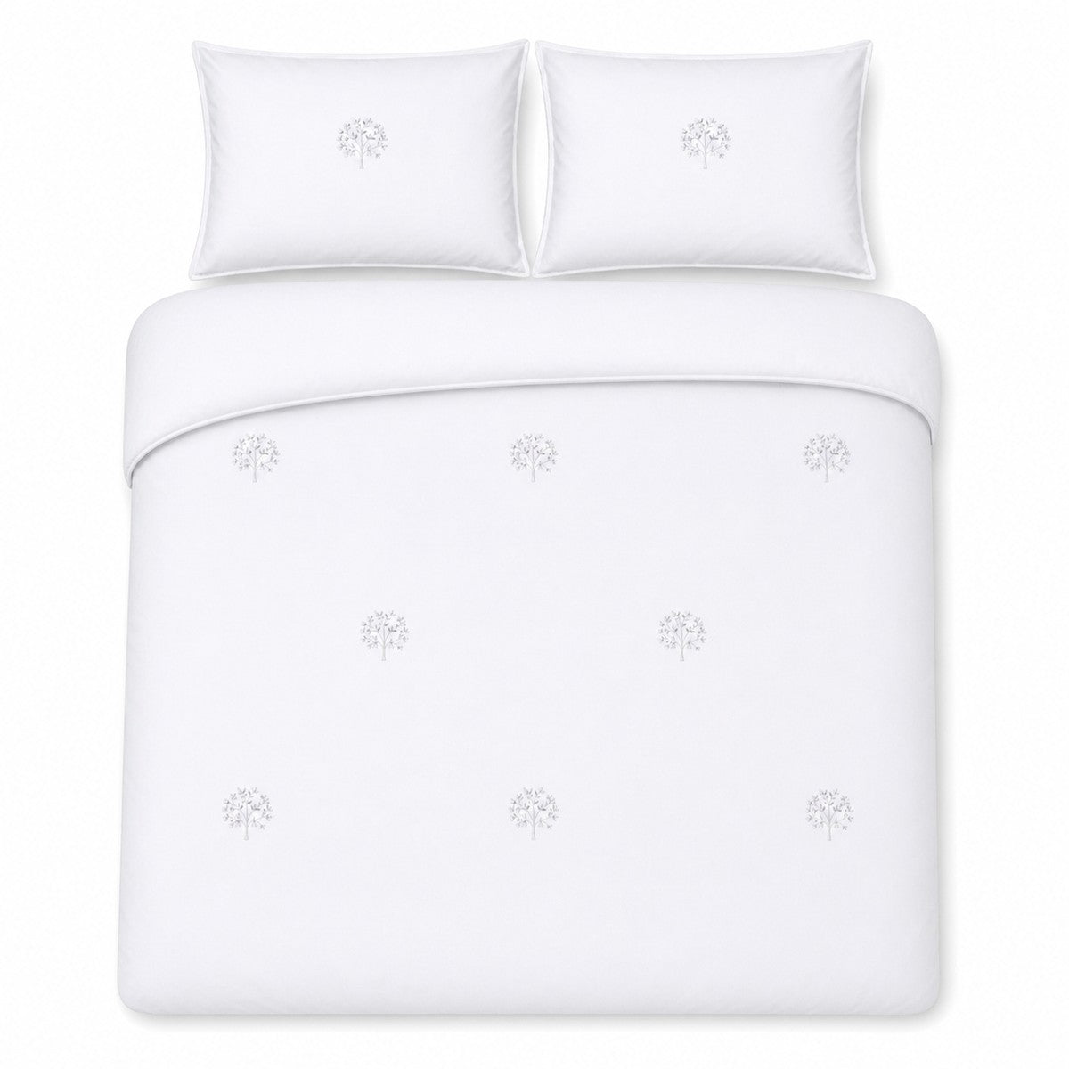 Overhead flat lay of the Embroidered Trees white cotton duvet cover set with two pillows