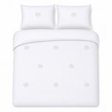 Overhead flat lay of the Embroidered Trees white cotton duvet cover set with two pillows