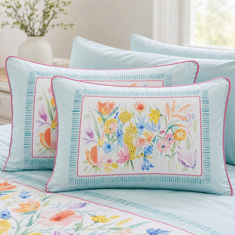 Close-up of Festival duck egg cotton pillowcases showing the floral panel and pink piping