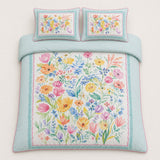 Overhead flat lay of the Festival duck egg floral cotton duvet cover set with two pillows