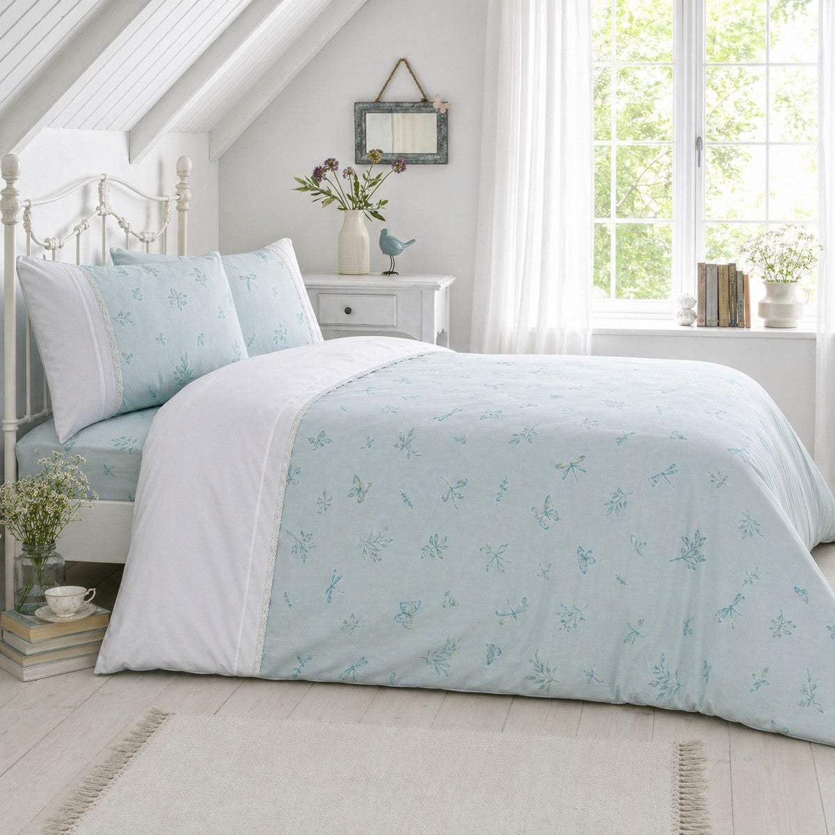 Fifi duck egg botanical polycotton duvet cover set styled on a bright bedroom bed with lace trim detail