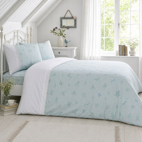 Fifi duck egg botanical polycotton duvet cover set styled on a bright bedroom bed with lace trim detail