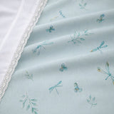 Macro close-up of the Fifi duck egg polycotton duvet fabric with botanical motifs and lace edge