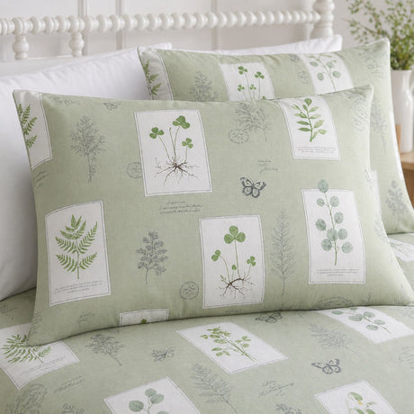 Close-up of Floral Garden green pillowcases showing pressed flower and butterfly print panels