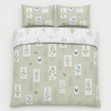 Overhead flat lay of the Floral Garden green reversible duvet cover set with two pillows