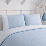 Close-up of Frampton Floral Polycotton Duvet Cover Set in blue pillowcases showing the print and fabric detail