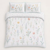 Overhead flat lay of the Gardenia floral cotton duvet cover set with two pillows
