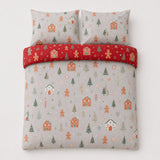 Overhead flat lay of the Gingerbread House Christmas Polycotton Duvet Cover Set with two matching pillowcases