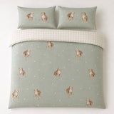 Overhead flat lay of the Hattie Cockapoo Dog Print Microfibre Duvet Cover Set in green with two matching pillowcases