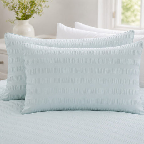 Close-up of Honley duck egg seersucker pillowcases showing the raised puckered stripe texture