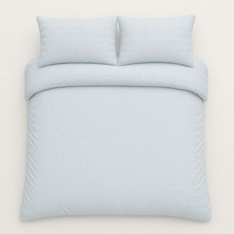 Overhead flat lay of the Honley duck egg seersucker duvet cover set with two pillows