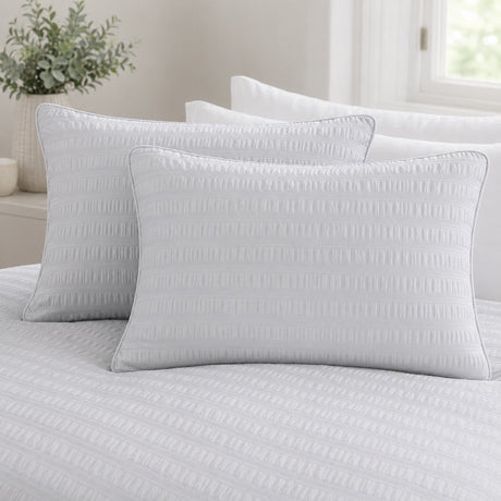 Close-up of Honley silver seersucker pillowcases showing the raised puckered stripe texture