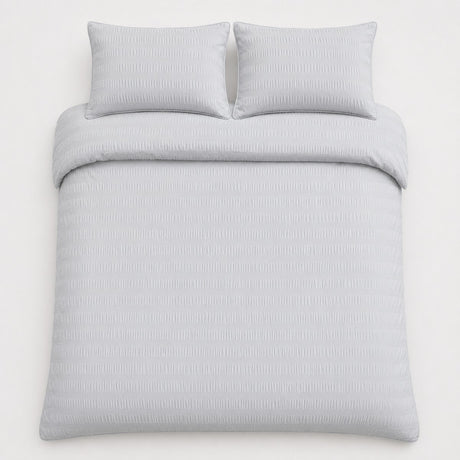 Overhead flat lay of the Honley silver seersucker duvet cover set with two pillows