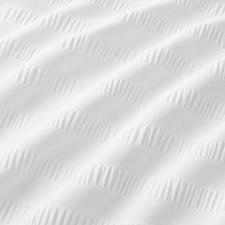 Macro close-up of Honley white seersucker microfibre fabric with raised textured stripes