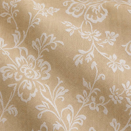 Macro close-up of the Jasmine champagne woven polycotton fabric with white floral vine detail