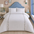 Julianna Embroidered 100% Cotton Duvet Cover Set in white styled on a coordinated bedroom bed