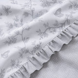 Macro close-up of the Kristen grey polycotton duvet fabric with floral print and dotted reverse
