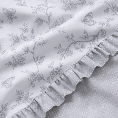 Macro close-up of the Kristen grey polycotton duvet fabric with floral print and dotted reverse