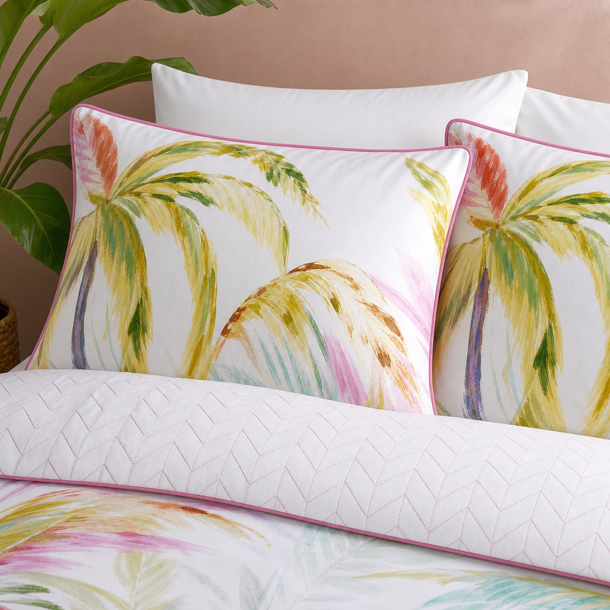 Close-up of Leilani Cotton Duvet Cover Set in green pillowcases showing the print and fabric detail