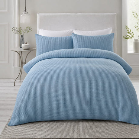 Lindly Waffle Microfibre Duvet Cover Set in blue styled on a coordinated bedroom bed