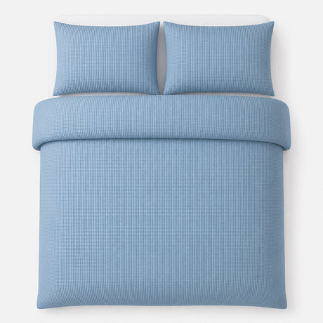 Overhead flat lay of the Lindly Waffle Microfibre Duvet Cover Set in blue with two matching pillowcases