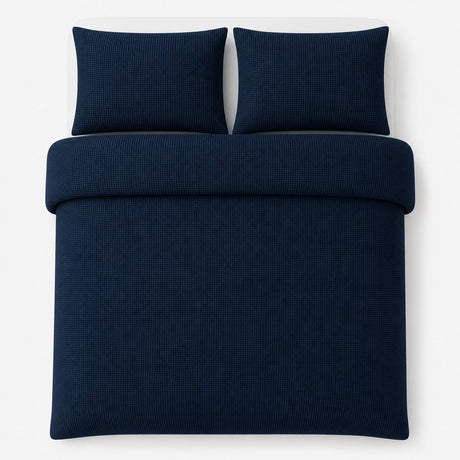 Overhead flat lay of the Lindly Waffle Microfibre Duvet Cover Set in navy with two matching pillowcases