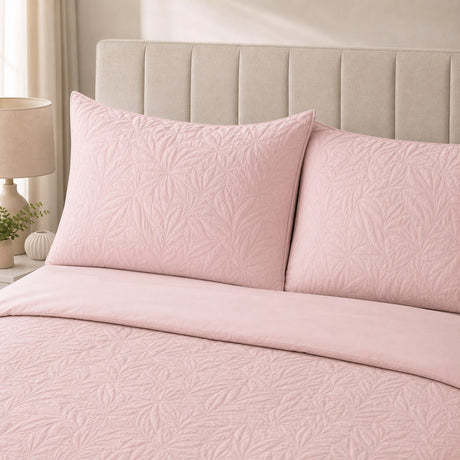 Close-up of Luana Blush pillowcases showing the raised leafy stitched pattern