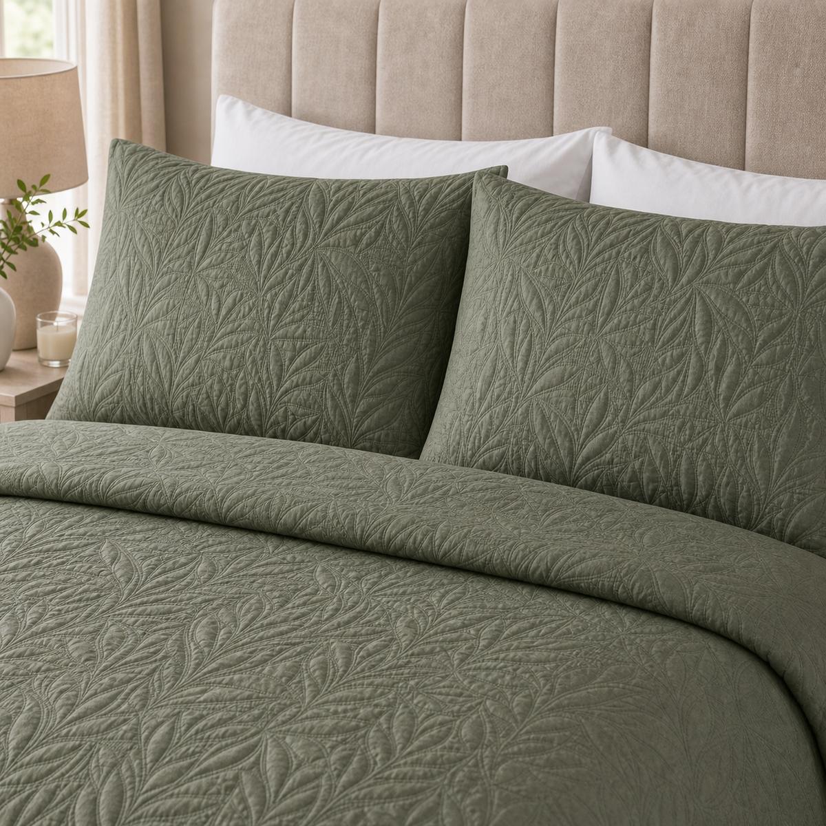 Close-up of Luana Dark Green pillowcases showing the raised leafy stitched pattern