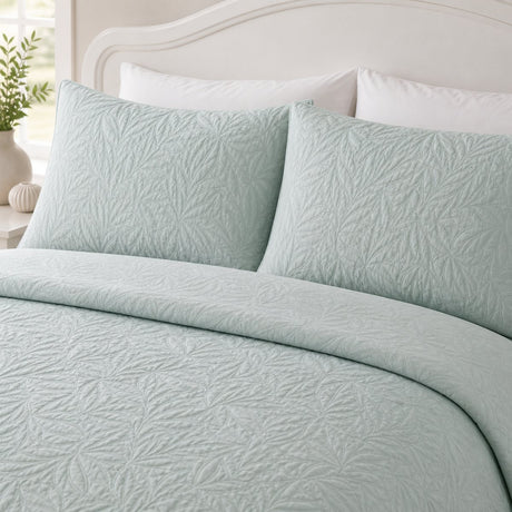 Close-up of Luana Green pillowcases showing the raised leafy stitched pattern