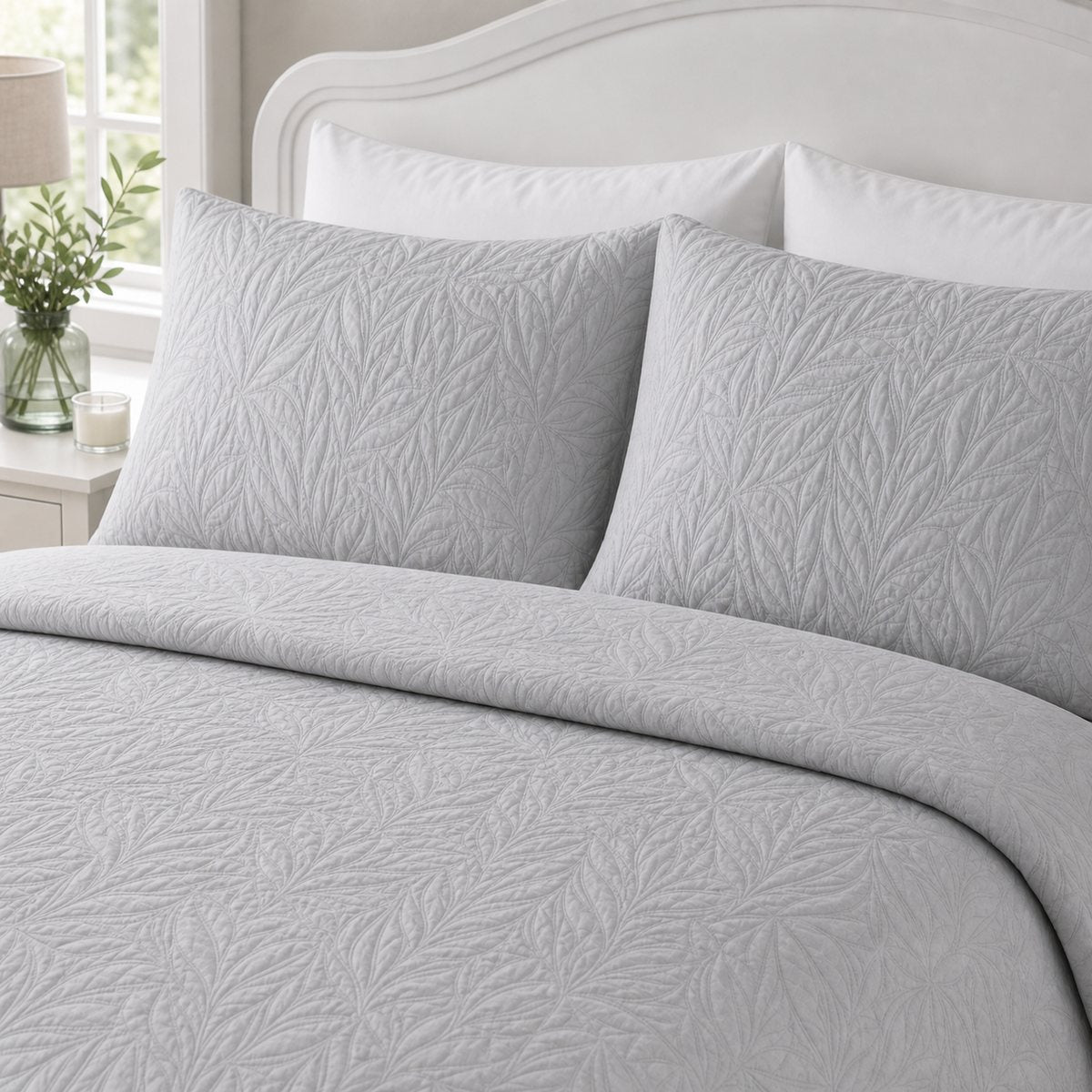 Close-up of Luana Silver pillowcases showing the raised leafy stitched pattern