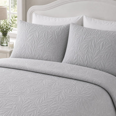 Close-up of Luana Silver pillowcases showing the raised leafy stitched pattern