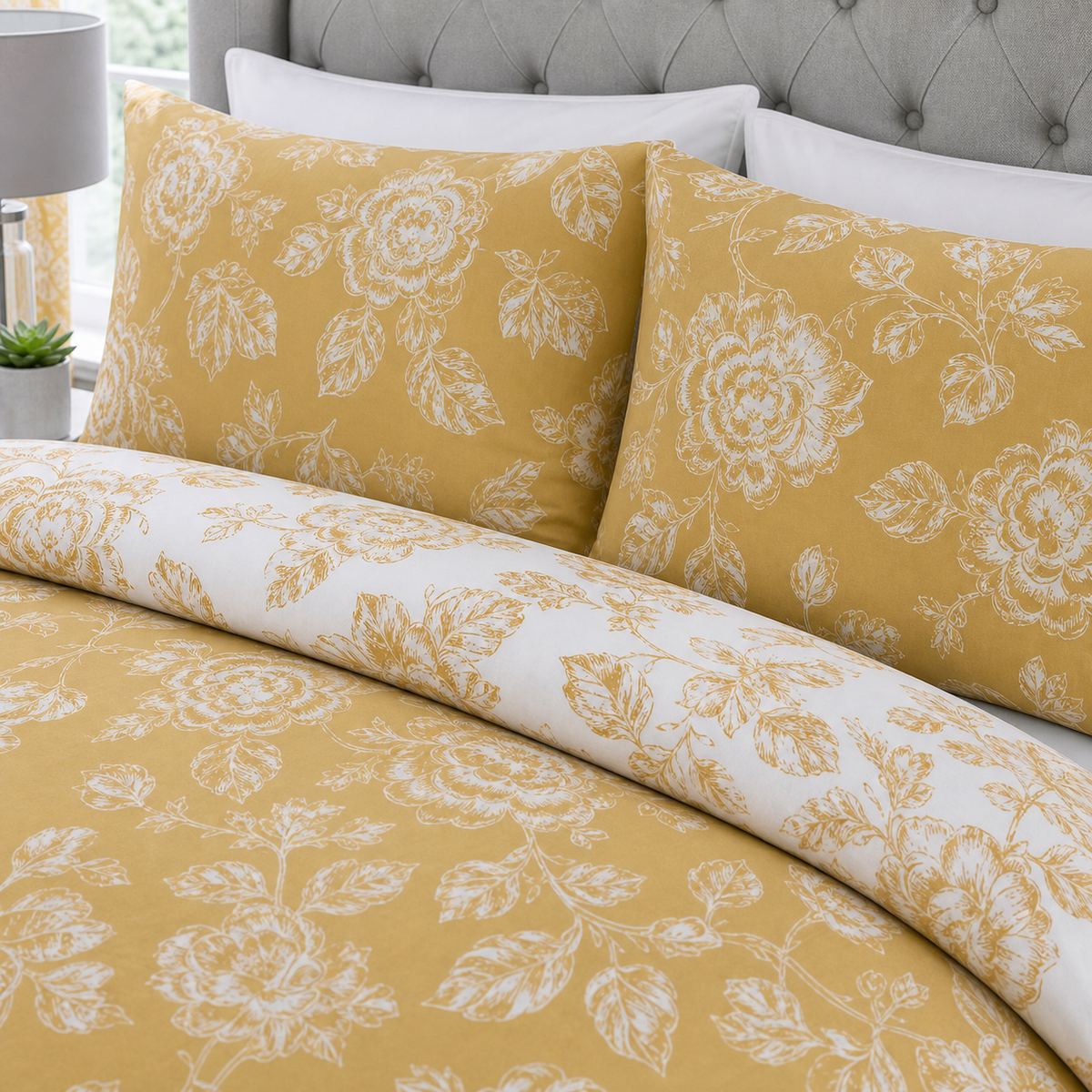 Close-up of matching Mishka Reversible Floral Gold Polycotton Duvet Cover Set pillowcases showing the pattern and fabric detail