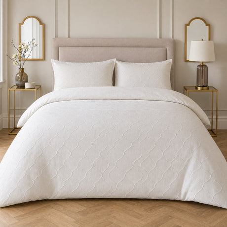 Montez Jacquard Beige Duvet Cover Set styled on a neutral bedroom bed showing the raised ogee jacquard pattern