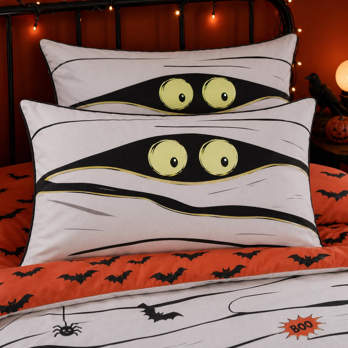Close-up of Mummy Halloween pillowcases with yellow eyes and orange bat reverse