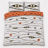 Overhead flat lay of the Mummy Halloween duvet cover set with orange bat reverse