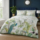 Peacock Jungle green polycotton duvet cover set styled on a bedroom bed