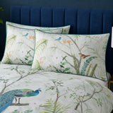 Close-up of Peacock Jungle green pillowcases with tropical leaves and peacock print