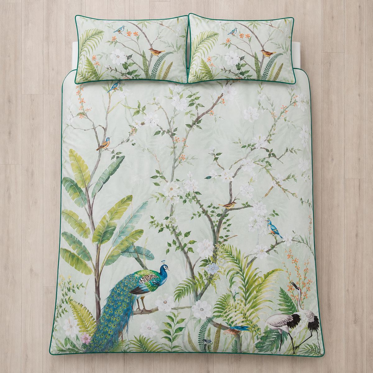 Overhead flat lay of the Peacock Jungle green duvet cover set with two matching pillowcases
