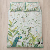Overhead flat lay of the Peacock Jungle green duvet cover set with two matching pillowcases