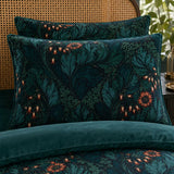 Close-up of Rambleicious velvet pillowcases with teal scrolling leaves and coral flower print