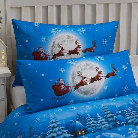 Close-up of matching Santa Glow in the Dark Christmas Polycotton Duvet Cover Set pillowcases showing the pattern and fabric detail