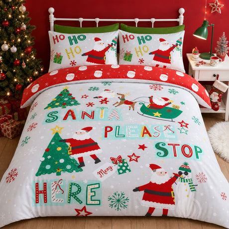 Santa Please Stop Here Christmas microfibre duvet cover set styled on a festive bed with readable seasonal lettering