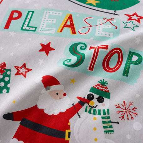 Macro close-up of the Santa Please Stop Here microfibre duvet cover fabric with festive printed lettering and motifs