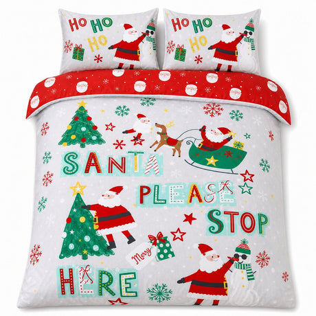 Overhead flat lay of the Santa Please Stop Here Christmas duvet cover set with two matching pillowcases