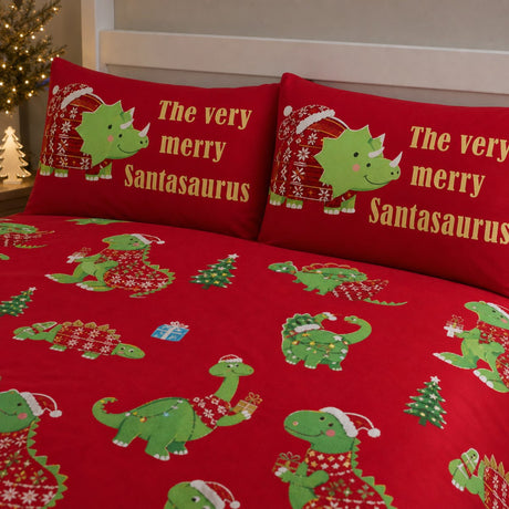 Close-up of matching Santasaurus Kids Christmas Polycotton Duvet Cover Set pillowcases showing the pattern and fabric detail